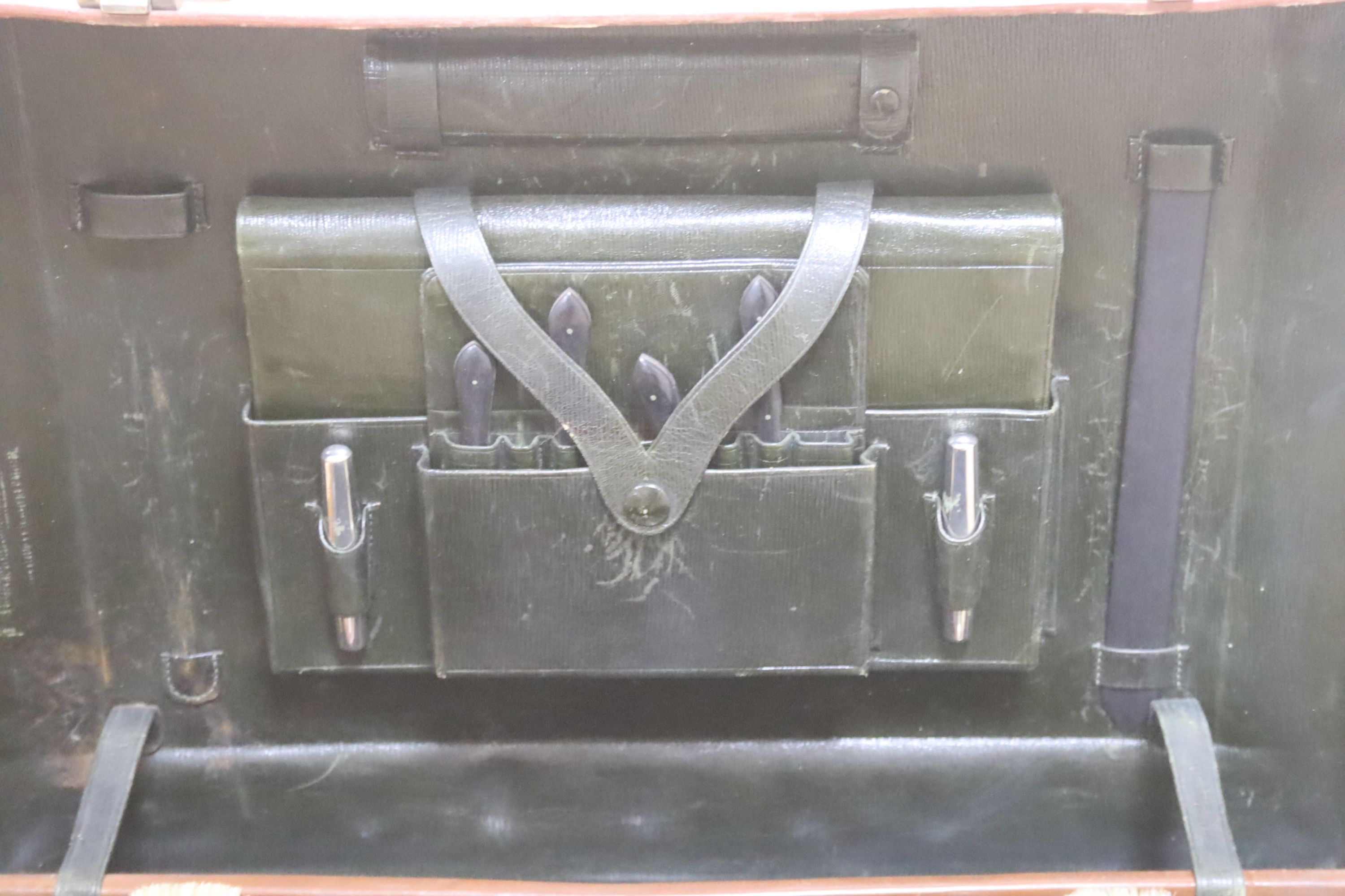 A gentleman's brown leather cased silver travelling vanity set, with silver lidded bottles interior, initialled HS